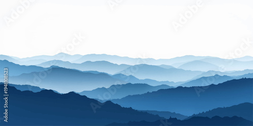 Misty mountain landscape featuring snowy peaks and a forest valley under a blue sunrise sky with clouds and fog at dawn.