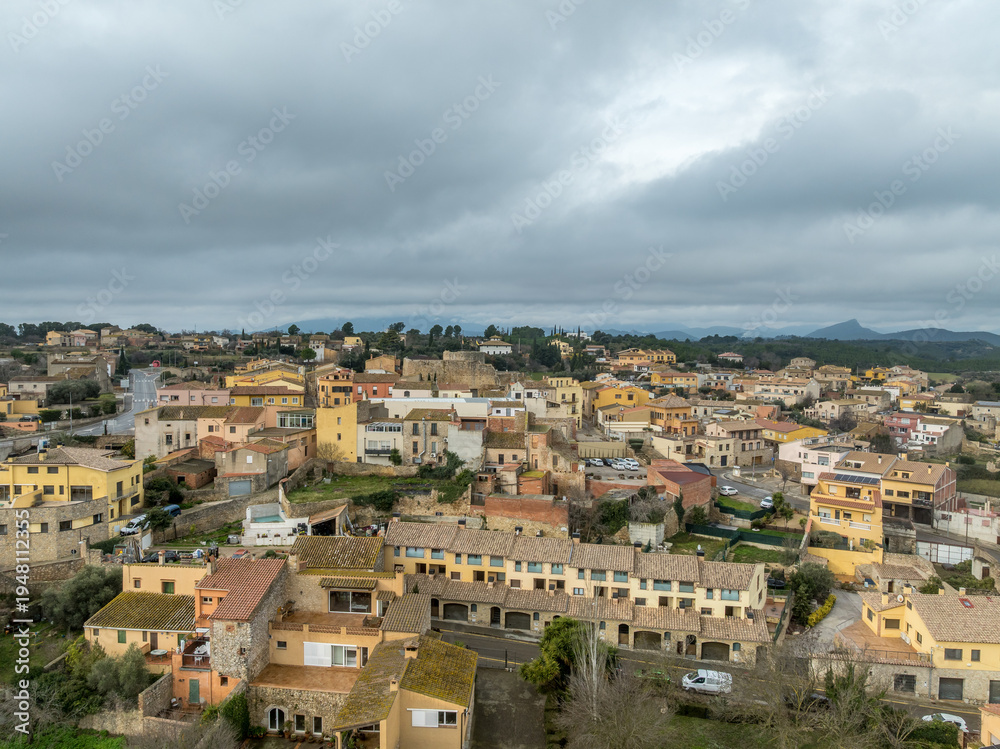 Obraz premium Aerial top down view of Llers Castle located in the Alt Empordà region of Catalonia, Spain. Round keep in the middle of a medieval village