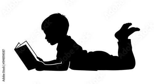 Silhouette of a young boy lying on his stomach and reading a book with a white background.