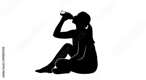 A silhouette of a person sitting on the ground and drinking from a bottle.