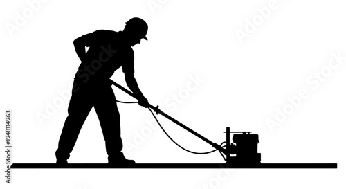 Silhouette of a construction worker operating a power trowel to finish a concrete floor.