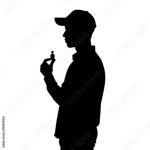 Silhouette of a man wearing a cap, holding a small chess piece, contemplating strategy.