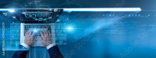 Photos Specialist using laptop with content management system on keyboard and analysis