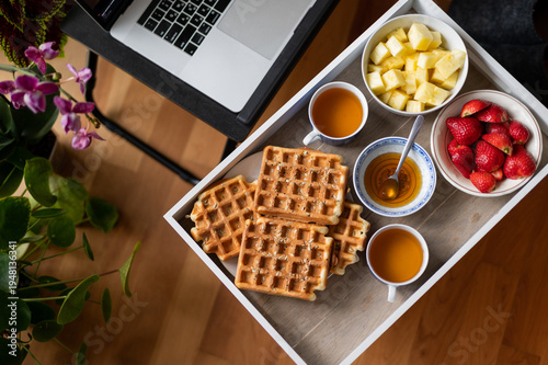 Breakfast while watching movie on laptop at home
