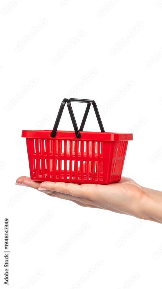 Fototapeta premium Red plastic shopping basket on a hand, isolated on white background