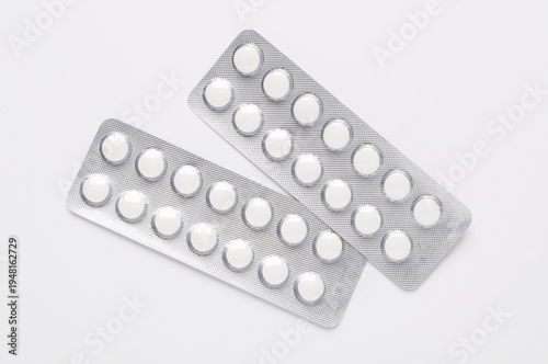 Foil Blister packs containing pills medication on white background with copy space
