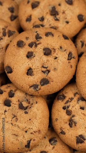 Heap of sweet chocolate chip cookies close up, rotation