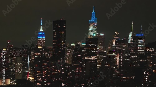 Night lights shine over New York City skyline in aerial view