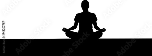 Person meditating at sunrise silhouette.