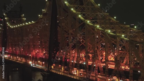 View of Queensboro Bridge lit up at night in New York City