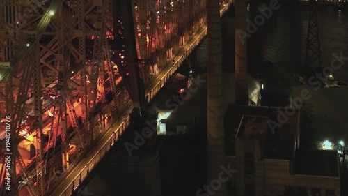 Aerial view of a bridge in New York at night showing lights and structures
