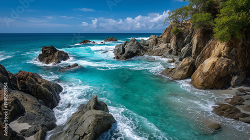 Seascape of beautiful clear turquoise water rugged coastline, rocks, ocean waves and vibrant blue sky