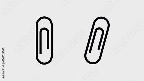 Two black paper clips on light gray background