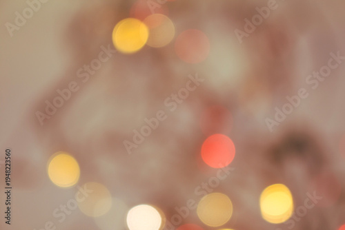 Soft warm bokeh light circles blurred on a neutral background, creating a calm, dreamy, and decorative abstract atmosphere.