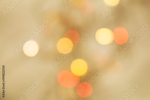 Abstract warm bokeh light circles softly blurred on a neutral beige background, creating a calm and elegant decorative atmosphere.