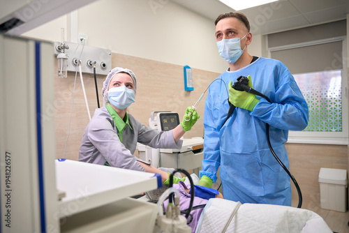 Canvas Print Doctor and nurse performing endoscopy in hospital room