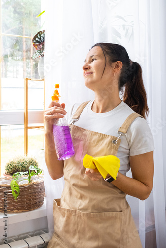 Overworked tired woman in kitchen with cleaning supplies, spring burnout, cleaning business solution, modern bright interior, add for cleaning company services