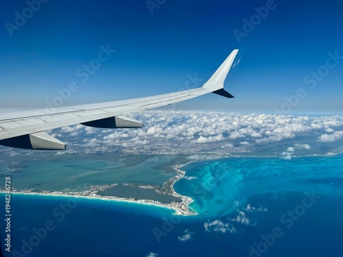 Fotografija View from airplane window of airplane wing above Mexican coastline including Can