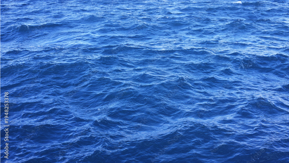 Obraz premium Blue ocean water surface texture with gentle waves