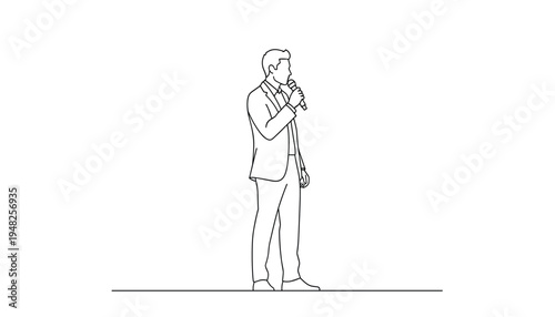A man in a suit holding a microphone and preparing to speak or sing