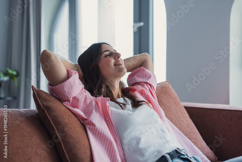 Quadro em tela Relaxed serene pretty young woman feel fatigue lounge on comfortable sofa hands