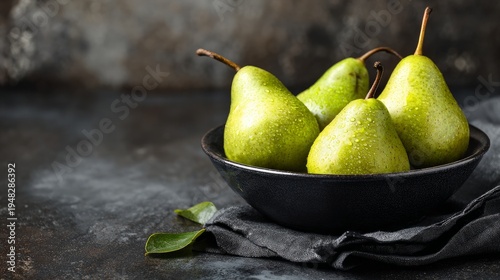 Juicy pears sit in a bowl on a dark stone surface, ready for your message.