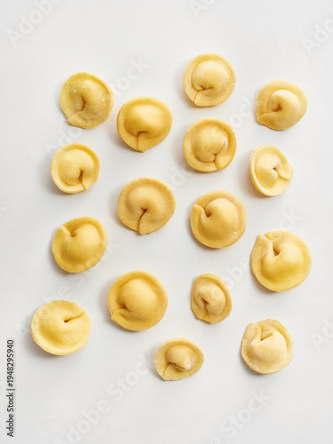 The image showcases a collection of freshly made tortellini arranged on a light background. Ideal for restaurant menus, food blogs, and culinary social media content