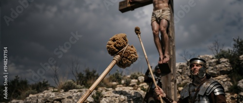 Close-up of a sponge on a reed offered to Jesus on the cross. Roman soldier standing guard at the crucifixion on Golgotha. Good Friday biblical scene