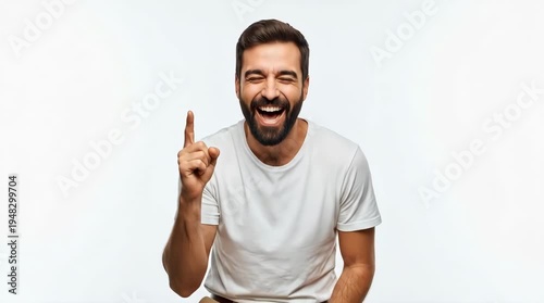 A smiling man with a beard pointing upwards in a moment of inspiration