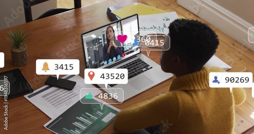 Reviewing woman in mustard sweater studying charts on laptop call with alerts at home, copy space