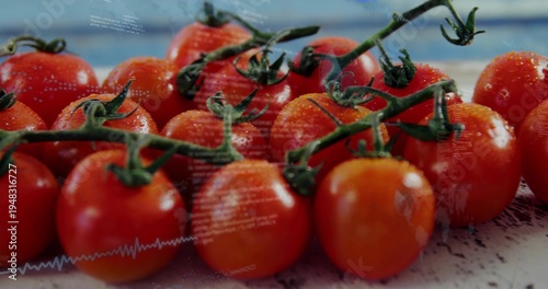 Showing cluster ripe cherry tomatoes on vine on light counter, green stems, water drops, overlay