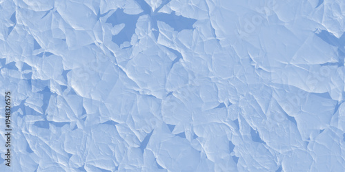 Abstract Ice Texture: An intricate, abstract pattern of fractured ice, revealing delicate crystal formations and subtle blue hues under natural light.