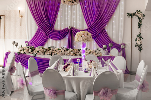 Photography Elegant wedding reception hall with purple drapery and floral decor