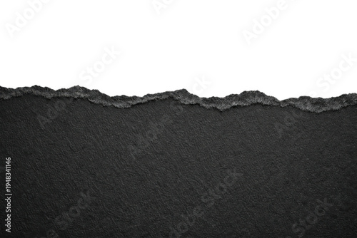 Torn black paper edge on a white background, creating a textured border for design elements, copy space, or abstract concepts
