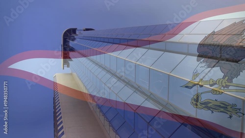 Glass tower staying framed while translucent flag drifting after gust, showing eagle emblem