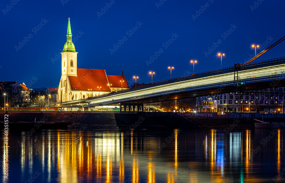 Fototapeta premium Bratislava night skyline with St Martins Cathedral bridge and reflections