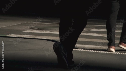 Slow motion shot of feet in a city crosswalk