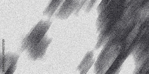 Abstract monochrome grainy texture with diagonal blurred dark brush strokes and speckled noise creating a dynamic and textured background effect for design projects
