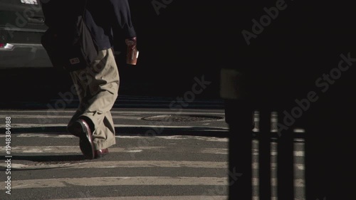 Slow motion shot of feet in a city crosswalk