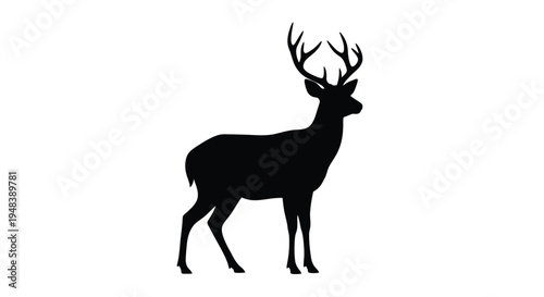 Silhouette of a majestic stag with large antlers standing in profile