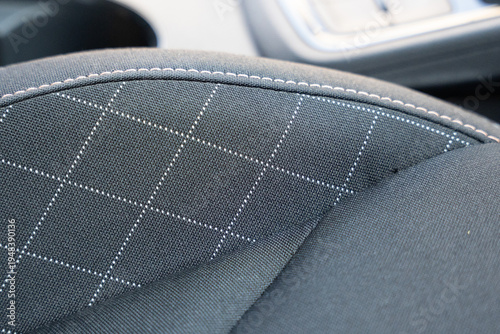 Cuadro en lienzo Close-up of a car seat fabric showcasing a stitched grid pattern that reflects a modern design aesthetic