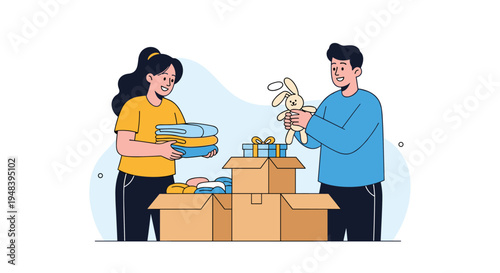 Volunteers packing clothes and toys into cardboard donation boxes for charity and community support project.