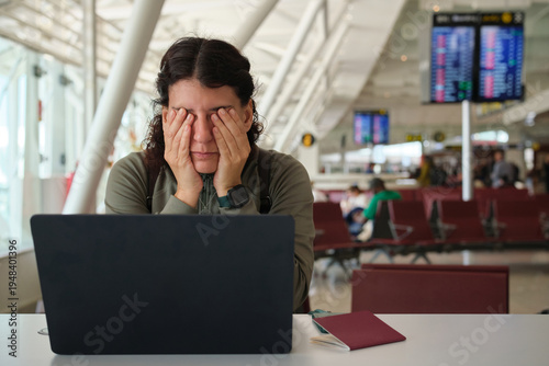 Photos Tired woman rubbing eyes at airport experiencing flight delay