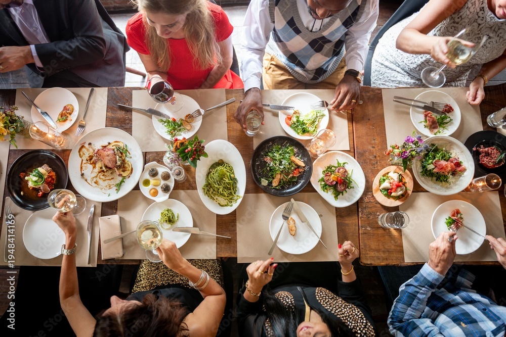 Fototapeta premium Diverse group enjoying meal together.