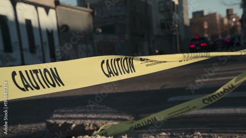 Slow motion shot of caution tape on a city street