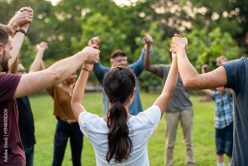 Tableau sur toile Diverse group holding hands outdoors