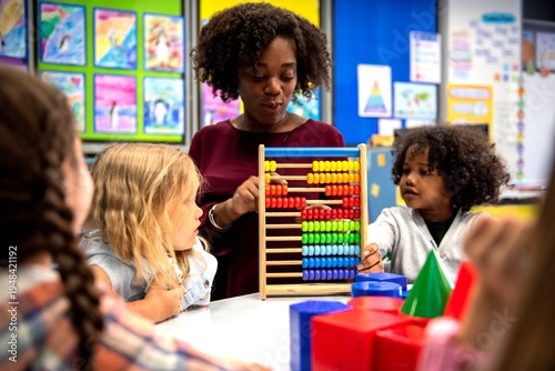 Fotografija Teacher guiding children with abacus.