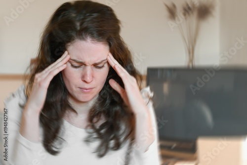 Obraz na plátně Blured photo of a woman suffering from vertigo or dizziness or other health problem of brain or inner ear