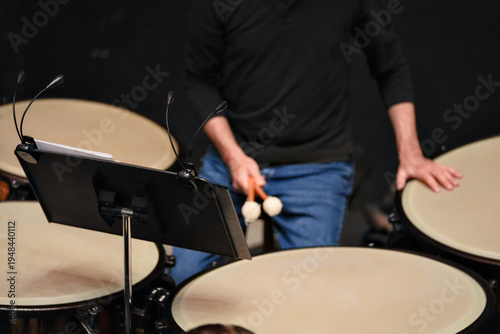 Tableau sur toile Cropped view of percussionist playing timpani on stage indoors