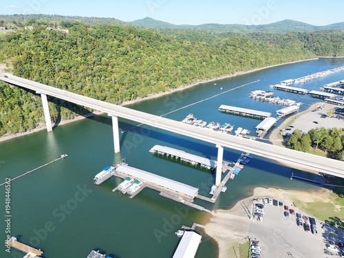 Wallpaper Mural Aerial View of the Lakeside Sunset Marina Resort on Dale Hollow Lake With Highway 111 Bridge, Boats and Forested Shoreline, Calm Water on a Sunny Day, Monroe, Tennessee, USA. Torontodigital.ca